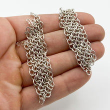 Load image into Gallery viewer, 4-in-1 chainmail sections removed from earring hooks and held in a hand, showing the 4-in-1 pattern and the small S-hooks that attach to the hook earring base