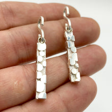 Load image into Gallery viewer, Rectangular earring dangles with bubble-like raised texture, held flat on fingers
