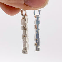 Load image into Gallery viewer, Rectangular earring dangles with bubble-like raised texture, hanging from s-hooks held in hand, three quarters view and side view
