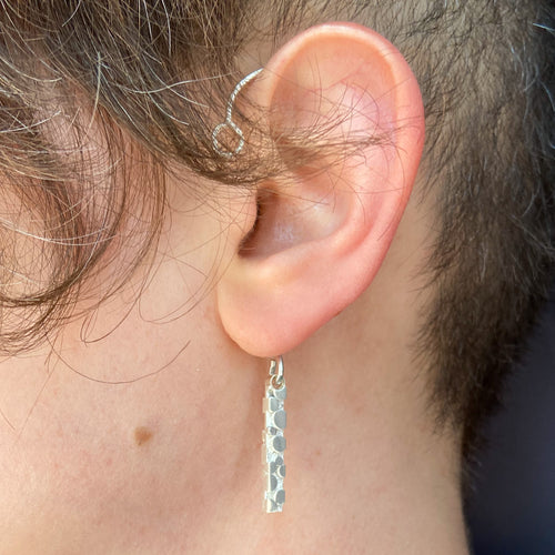 Whole ear cuff with bubble texture worn on ear, shown side view, closeup