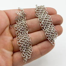 Load image into Gallery viewer, 4-in-1 chainmail sections removed from earring hooks and held in a hand, showing the 4-in-1 pattern and the small S-hooks that attach to the hook earring base
