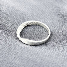 Load image into Gallery viewer, Twisted texture ring on a grey knitted background, diagonal above side view.
