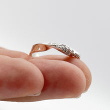 Load image into Gallery viewer,  Twist ring balanced on fingertips, tilted up for a slight underside view.
