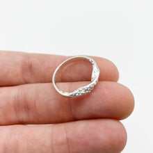 Load image into Gallery viewer, Twist ring balanced on fingertips, top down view
